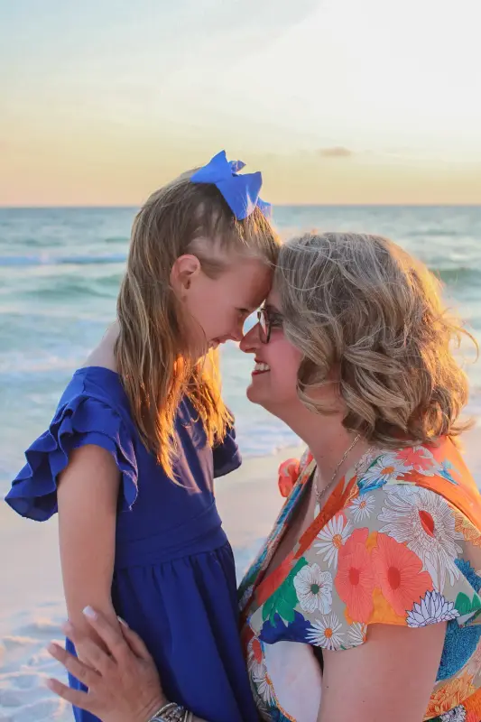 Child sharing a joyful moment by the ocean, photographed by Miranda Rae