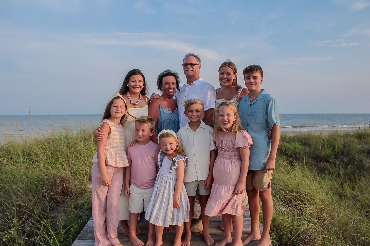 Extended family portrait on a beach boardwalk